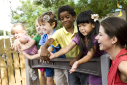 teacher and students playing bubbles outdoor